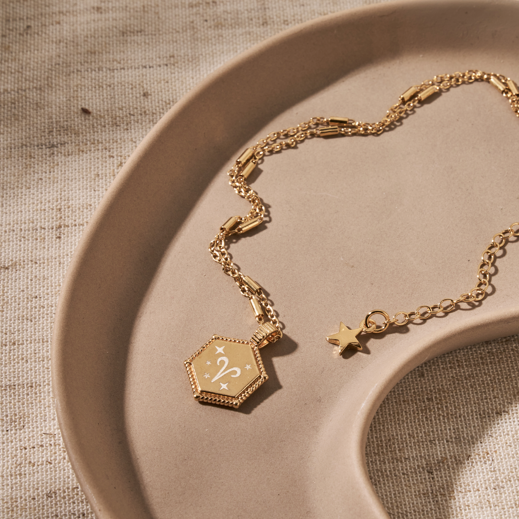 18ct gold plated hexagon coin necklace, engraved with the Aries zodiac symbol