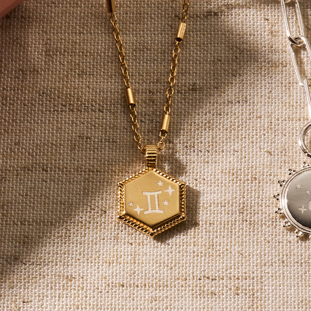 18ct gold plated hexagon coin necklace, engraved with the Gemini zodiac symbol